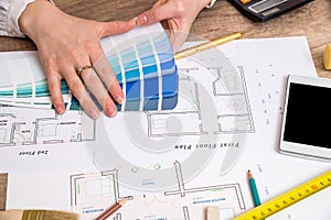 Architects hands working with drawing sketch home, color sample