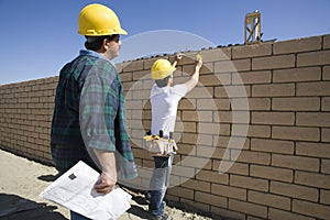 Architects Inspecting Brick Wall