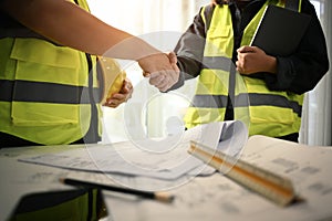 Architects and investor shaking hands after completing an agreement or successful construction project