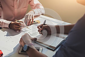 Architects meeting about construction project of house with blueprints in office. Construction and structure concept