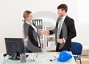 Architects shaking hands in the office