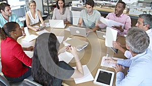 Architects Sitting Around Table Having Meeting