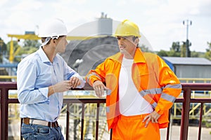 Architects standing against railing at construction site