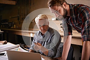 Architects, teamwork and father and son with laptop in workshop for building construction. Senior engineer, men and