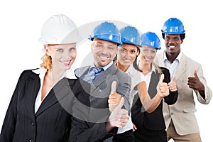 Architects wearing hardhats while gesturing thumbsup