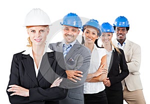 Architects Wearing Hardhats While Standing Arms Crossed