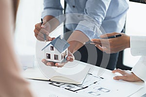 Architects who design buildings and houses are explaining examples of houses to project owners regarding house designs in housing