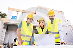 Architects and worker at the construction site.