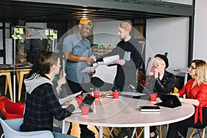 Architects, IT workers or designers Sitting At Table Meeting With Laptops And Tablets. Two creative Businessmen Making