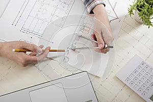 Architects working on blueprint, real estate project. Architect workplace - architectural project, blueprints, ruler