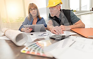 Architects working on plans, light effect