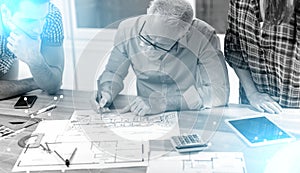 Architects working on plans; multiple exposure