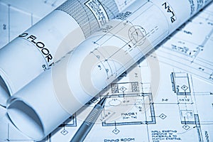 Architects workplace top view of blueprints. Architectural projects, blueprints, blueprint rolls on plans with pencil photo