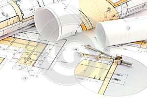 Architects workspace with blueprint, rolls and drawing compass