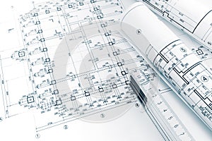 Architects workspace with project plans, rolled blueprints and f