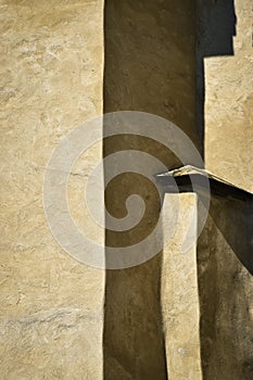 Detail of the wall with shadow of the historic building