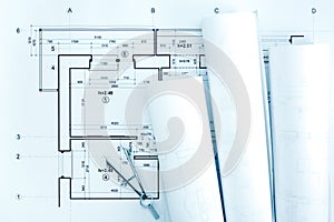 Architectural blueprint rolls with plan and drawing compass