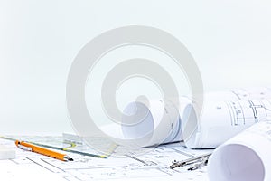 Architectural blueprint rolls and plans with drawing tools on de