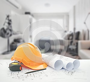 Architectural blueprint with safety helmet and tools over bedroom