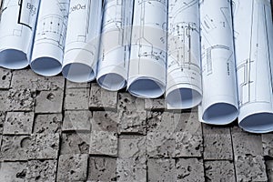 Architectural blueprints on grey wall backround