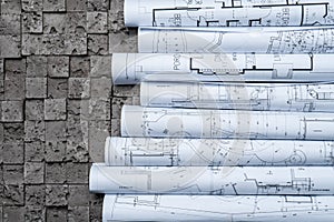 Architectural blueprints on grey wall backround
