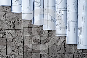Architectural blueprints on grey wall backround