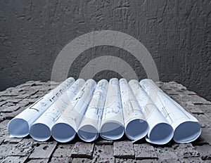 Architectural blueprints on grey wall backround