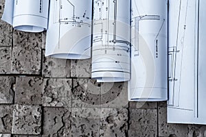 Architectural blueprints on grey wall backround