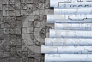 Architectural blueprints on grey wall backround