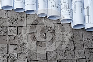 Architectural blueprints on grey wall backround