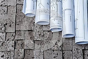 Architectural blueprints on grey wall backround