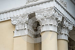 Architectural columns with figures and white stucco wealth.