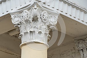 Architectural columns with figures and white stucco wealth.