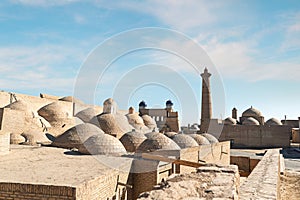 Architectural complex Palvan-darvaza of eastern gate of the Ichan-Kala fortress. Domes of Anush-Khan Bathhouse, trade