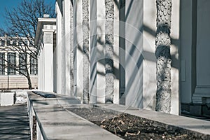 Architectural composition. The building with columns recedes into the distance. White walls. photo