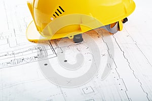 Architectural construction drawings background, builder hard hat on engineering blueprints with copy space