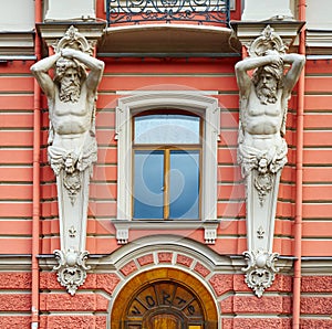 Architectural detail of facade in neo-Baroque style with figures of Atlantes photo