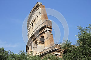 Architectural detail of the famous Roman Colosseum Coliseum against the blue sky. Close-up. Rome, Italy