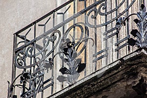 Architectural detail of a historic house in Treviso, wrought iron balcony railings. what was once normal today is an art. wrought