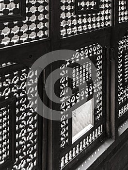 Architectural detail of Interleaved wooden ornate windows - Mashrabiya - at abandoned building photo