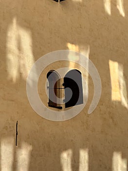 Open window on yellow wall in Stockholm