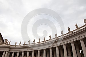 Architectural detail of saint peters basilica colonnade with statues on columns
