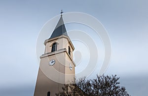Architectural detail of the steeple of a small traditional church in a small town in the Alsace