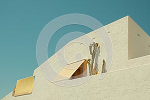 Architectural detail of white Mediterranean house by the sea in sunny day in Spain