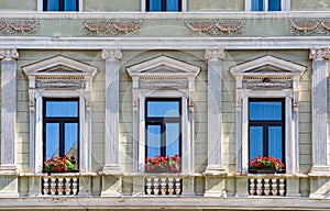 Architectural detail with the windows of an old building. Old vintage architecture in the center of Brasov, Romania