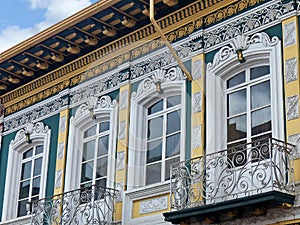 Vintage stucco facade with balcony, Cuenca, Ecuador