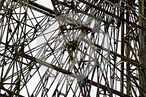 Architectural details of the metallic structure of a big ferris wheel. Old, rustic carousel details at circus outdoor