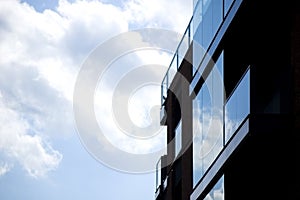 Architectural details of modern apartment building with reflections.