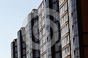 Architectural details of modern high apartment building facade with many windows and balconies