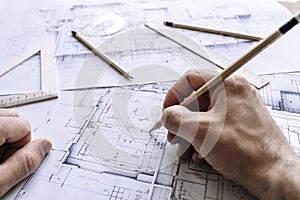 Architectural engineering design plan drawing on the table. Architect& x27;s work on table in studio. Construction design